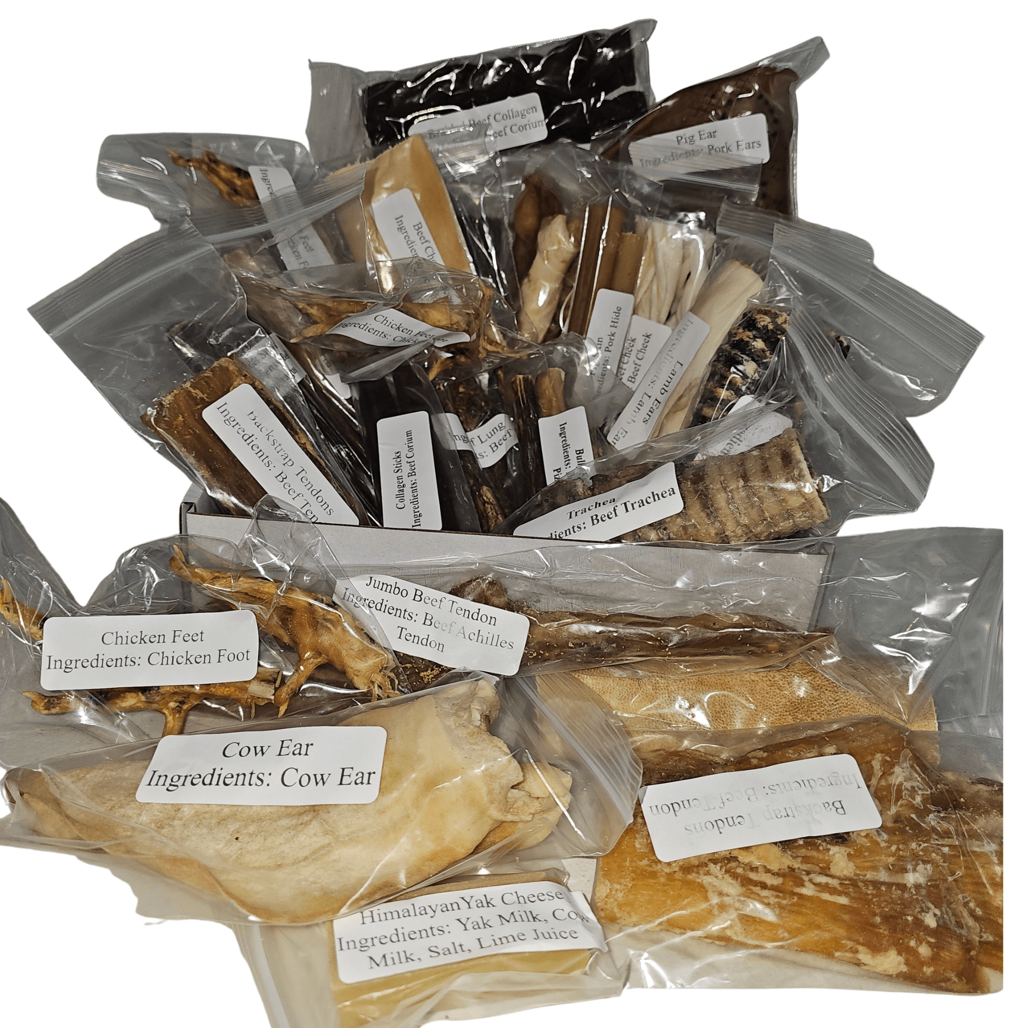 Deluxe Chomper Treat Box with various all-natural dog chews in clear packaging, including cow ear and chicken feet.