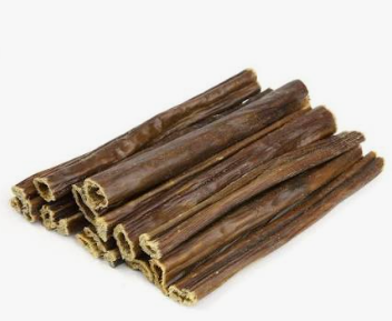 Eight brown, hollow Beef Gullet Sticks stacked in a pile against a white background.