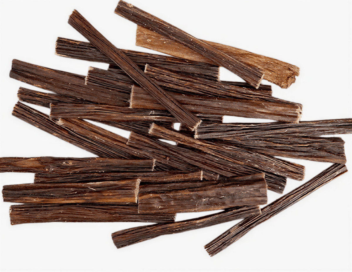 A pile of dark brown, textured Beef Gullet Sticks dog chews scattered on a white background.