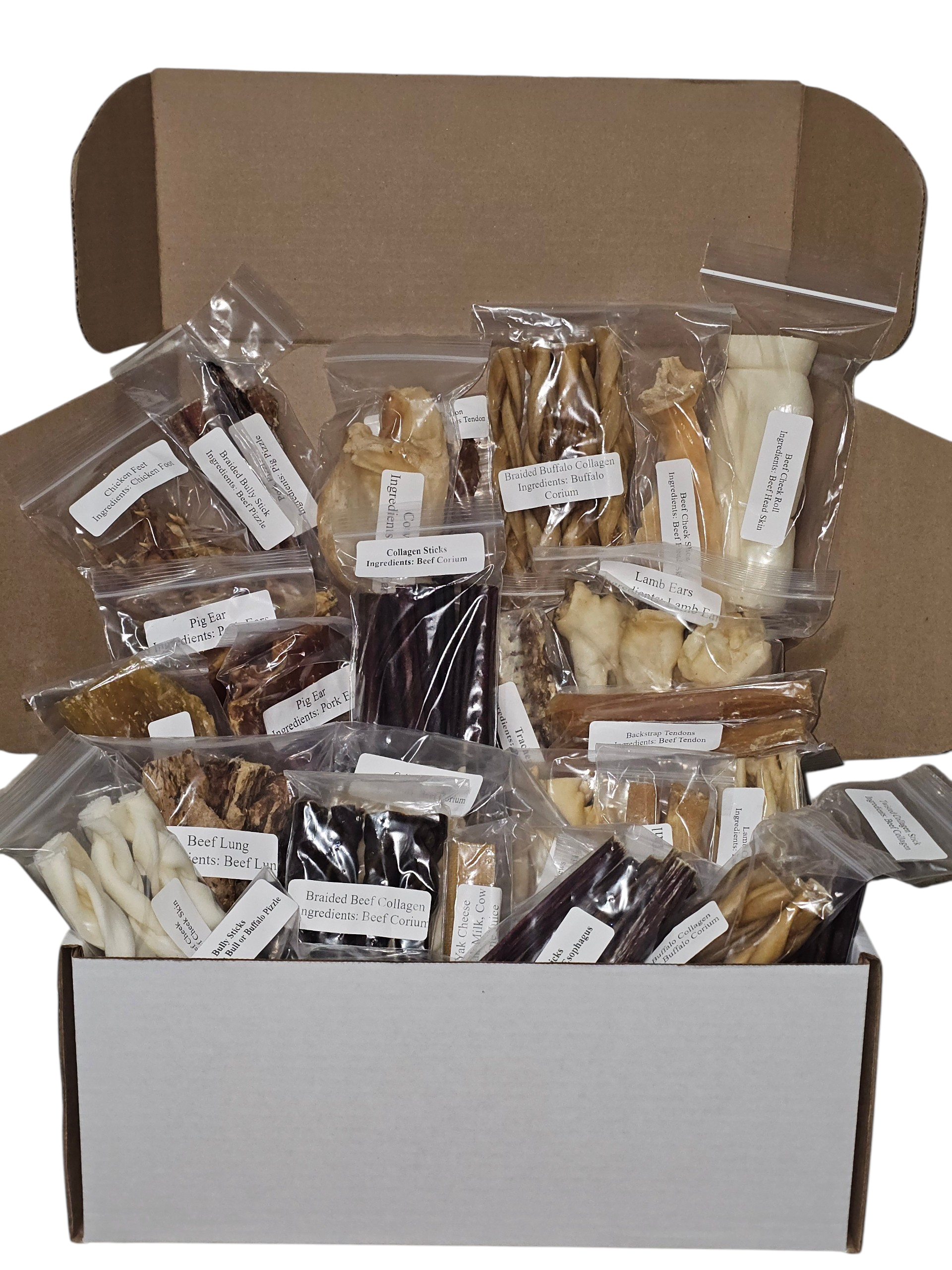 Open cardboard box filled with various brown and tan dog chews in clear plastic bags with white labels.